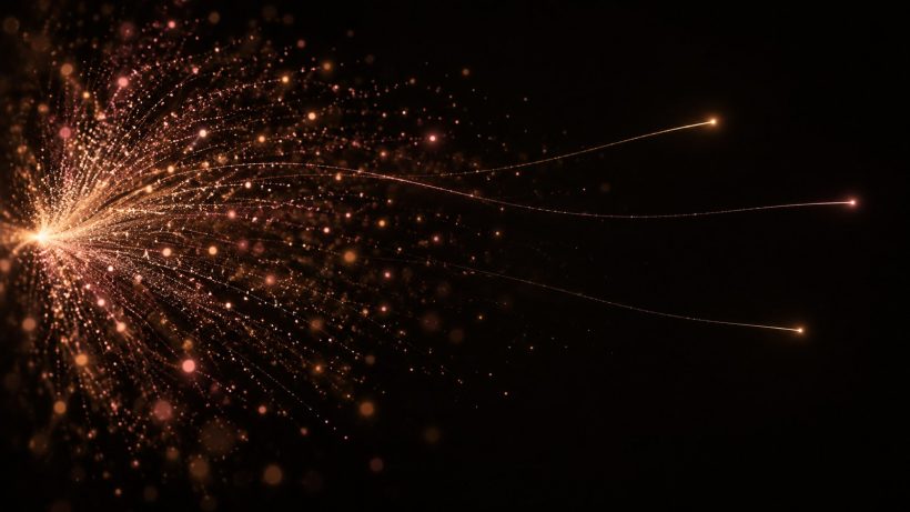 Abstract light study of a particle burst mostly fading, a few trails carrying across