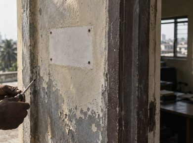Documentary photograph of an office doorway where a company nameplate has been removed